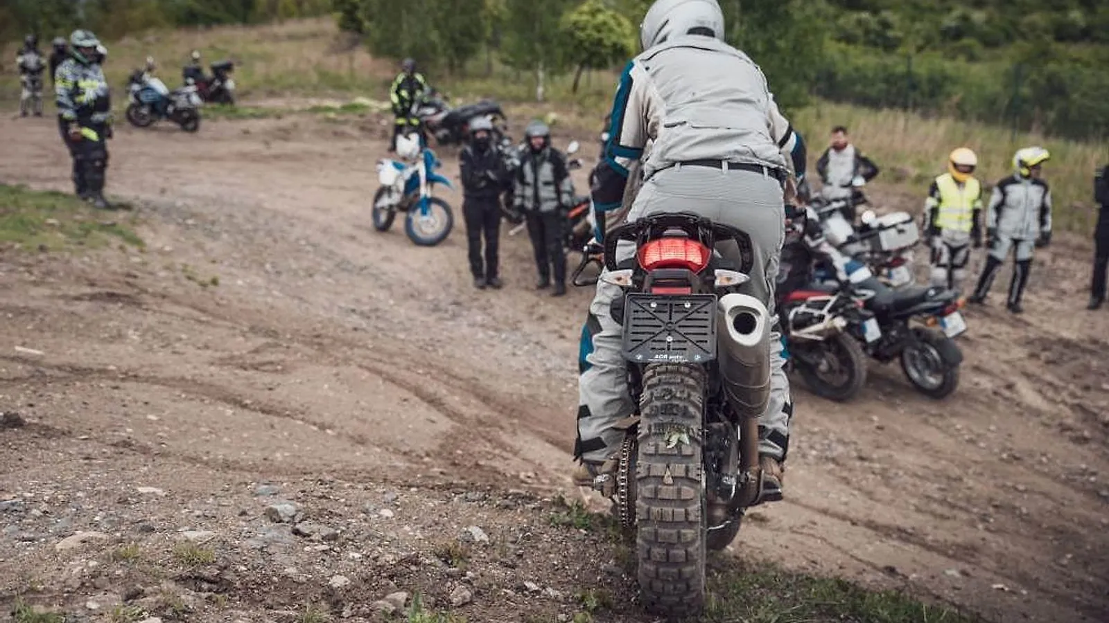 Skupina motorkářů s velkými endury na výcvikové ploše v terénu